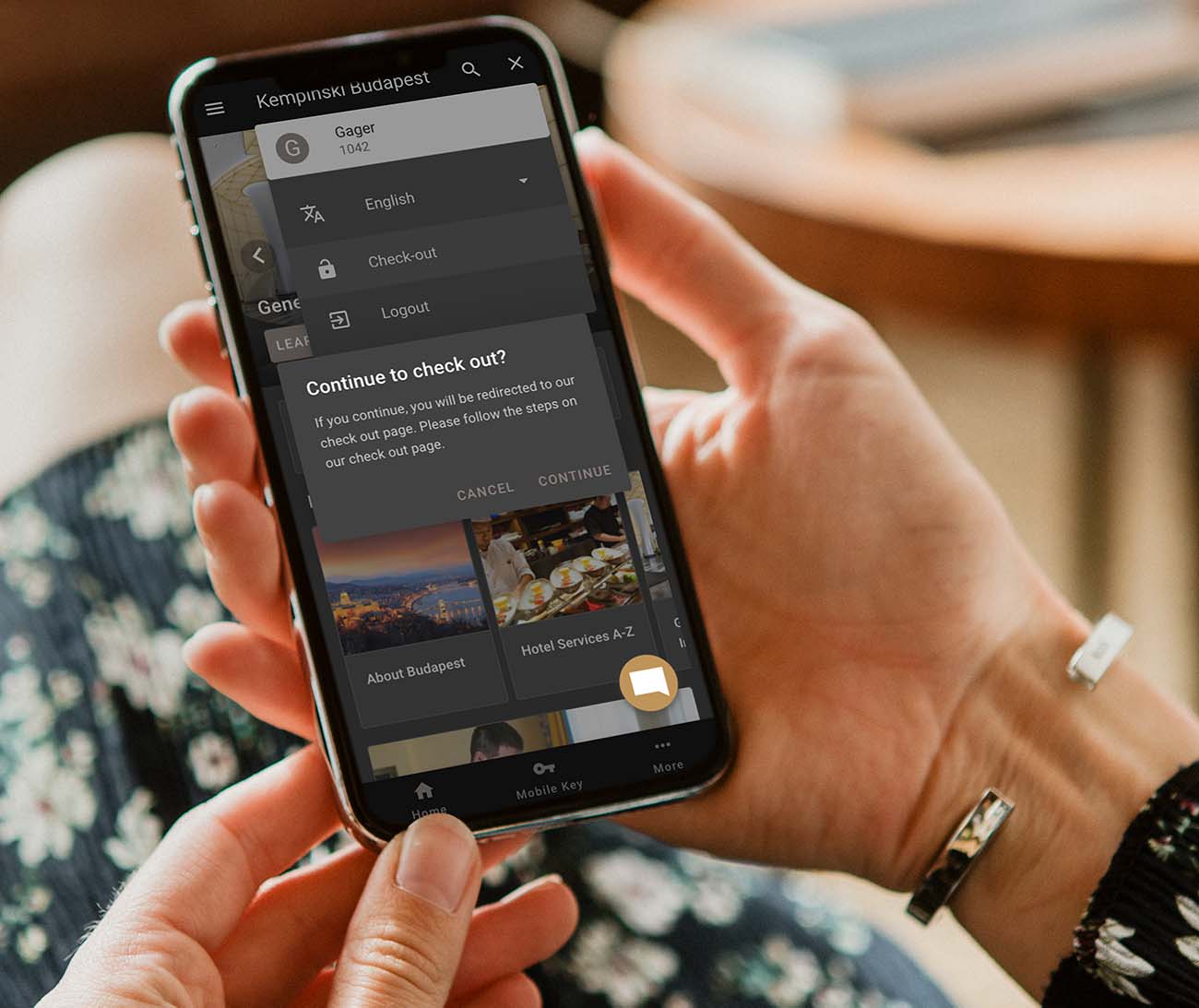 A guest checking in from their own phone in the hotel app, holding the device in both hands