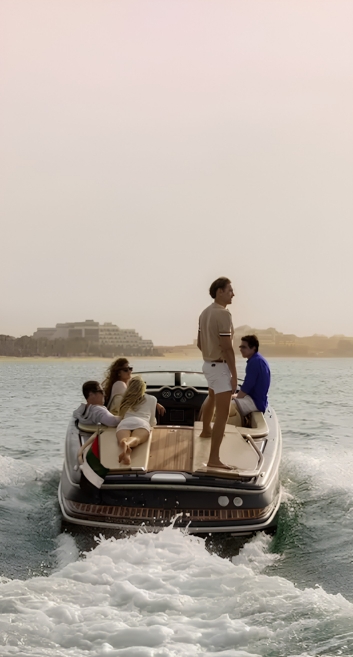 Guests enjoying a boat ride along a sunlit coastline