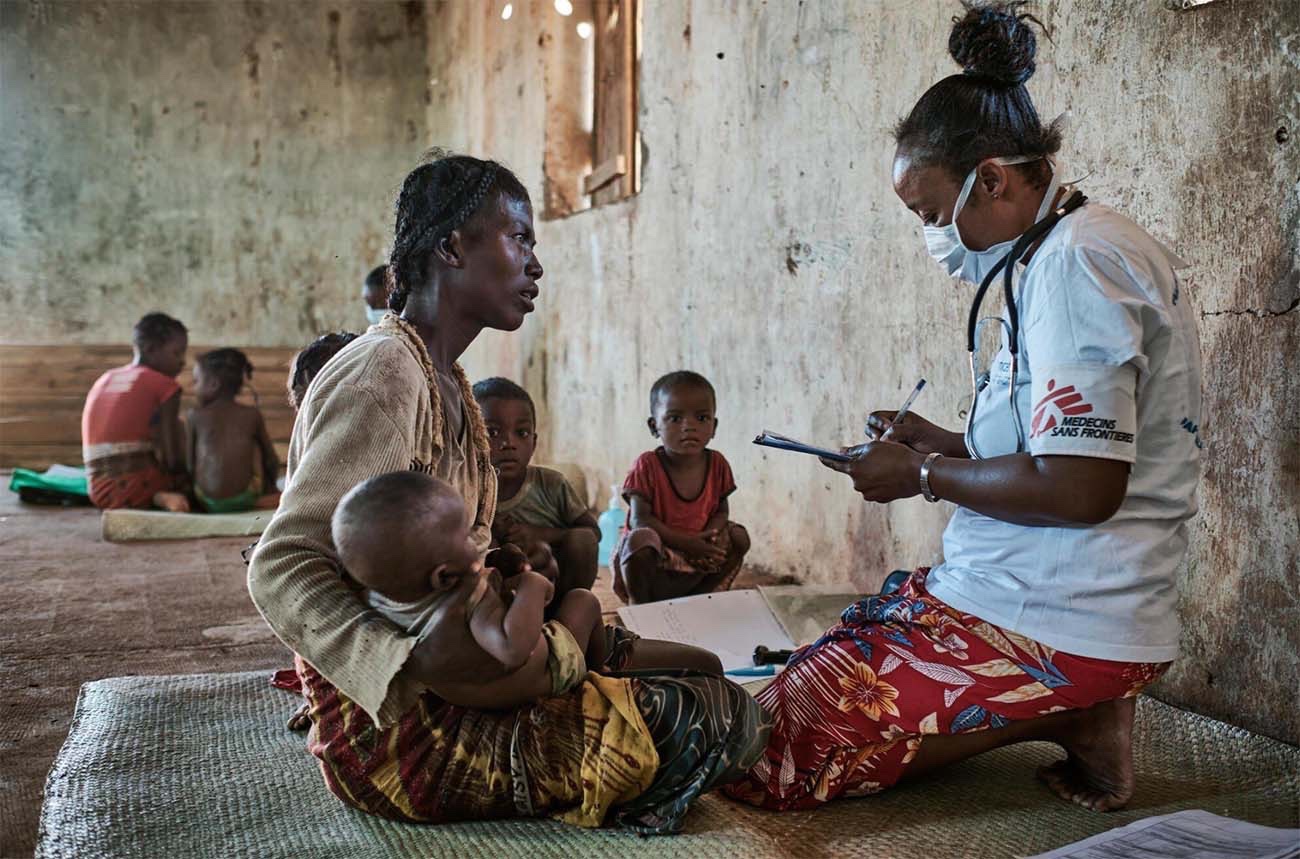 A Médecins Sans Frontières doctor caring for a mother and child