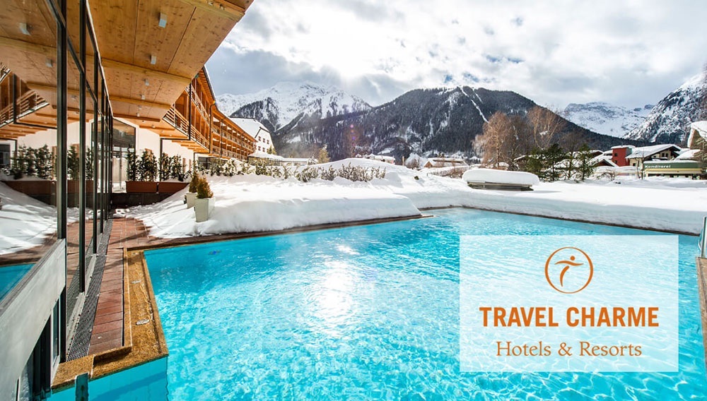 A Travel Charme resort pool in an alpine winter landscape