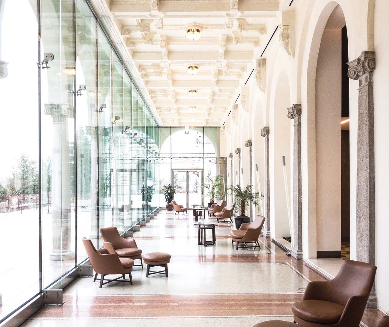A grand glass-walled hotel gallery and lounge corridor with full wireless coverage end to end